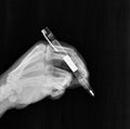 film xray x-ray or radiograph of a human hand with a writing utensil or pen drawing, writing, signing a document or autograph Royalty Free Stock Photo