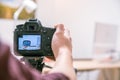 Filming with a digital camera: Man is using a camera standing on a tripod Royalty Free Stock Photo