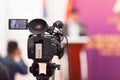 Filming an media event with a video camera. Press conference. Royalty Free Stock Photo