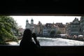 Filming woman upon a bridge over the river Reuss in Luzern