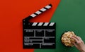 Filmmaking concept. Movie Clapperboard. Cinema begins with movie clappers. Movie clapper board on green and on red background and Royalty Free Stock Photo