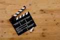 Filmmaking concept. Movie Clapperboard. Cinema begins with movie clappers. Movie clapper board on old wooden background Royalty Free Stock Photo