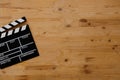 Filmmaking concept. Movie Clapperboard. Cinema begins with movie clappers. Movie clapper board on old wooden background Royalty Free Stock Photo