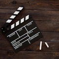 Filmmaking concept. Movie Clapperboard. Cinema begins with movie clappers. Movie clapper board on a wooden background. Square Royalty Free Stock Photo