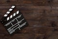 Filmmaking concept. Movie Clapperboard. Cinema begins with movie clappers. Movie clapper board on a wooden background Royalty Free Stock Photo