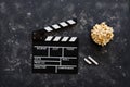 Filmmaking concept. Movie Clapperboard. Cinema begins with movie clappers. Movie clapper on a dark background and popcorn Royalty Free Stock Photo