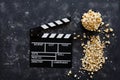 Filmmaking concept. Movie Clapperboard. Cinema begins with movie clappers. Movie clapper on a dark background and popcorn Royalty Free Stock Photo