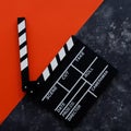 Filmmaking concept. Movie Clapperboard. Cinema begins with movie clappers. Movie clapper on a dark and red background. Square Royalty Free Stock Photo