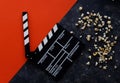 Filmmaking concept. Movie Clapperboard. Cinema begins with movie clappers. Movie clapper on a dark and red background and a Royalty Free Stock Photo