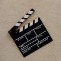 Filmmaking concept. Movie Clapperboard. Cinema begins with movie clappers. Movie clapper on a light texture background and popcorn Royalty Free Stock Photo