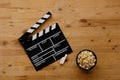 Filmmaking concept. Movie Clapperboard. Cinema begins with movie clappers. Movie clapper on an old wooden background and popcorn Royalty Free Stock Photo