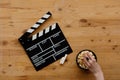 Filmmaking concept. Movie Clapperboard. Cinema begins with movie clappers. Movie clapper on an old wooden background and popcorn Royalty Free Stock Photo