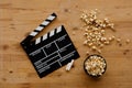 Filmmaking concept. Movie Clapperboard. Cinema begins with movie clappers. Movie clapper on an old wooden background and popcorn Royalty Free Stock Photo