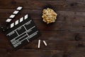 Filmmaking concept. Movie Clapperboard. Cinema begins with movie clappers. Movie clapper on a wooden background and popcorn Royalty Free Stock Photo