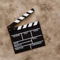 Filmmaking concept. Movie Clapperboard. Cinema begins with movie clappers. Movie clapper board on a textural background. Square Royalty Free Stock Photo