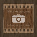 Filmstrip template with photo camera on wooden background Royalty Free Stock Photo