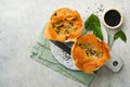 Filo pies with soft feta cheese and spinach in ceramic molds on old grey table background. Filo portions pies. Small Baked