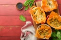 Filo pies with soft feta cheese and spinach in ceramic molds on old red wooden table backgrounds. Filo portions pies. Small Baked