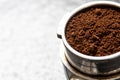 Filter holder for espresso coffee machine with coffee powder in detail. Italian espresso and fresh grinded coffee beans