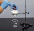 Filter paper in laboratory. Scientists are chemical filtration by filtering through filter paper in a glass funnel, Close up. Phar Royalty Free Stock Photo