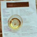 Filtered image wine taste concept with glass of dry white wine and tasting menu