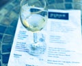 Filtered image wine taste concept with glass of dry white wine and tasting menu