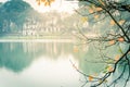 Filtered image yellow leaves of freshwater mangrove and Tortoise Tower at Hoan Kiem Lake, Hanoi