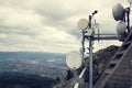 Filtered picture of security camera with transmitters and aerials on telecommunication tower Royalty Free Stock Photo