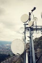 Filtered picture of security camera with transmitters and aerials on telecommunication tower Royalty Free Stock Photo