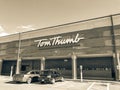 Filtered tone entrance of Tom Thumb grocery store under cloud bl