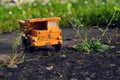 Filtered vintage orange car toy truck on green grass detail Royalty Free Stock Photo