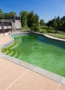 Filthy backyard swimming pool and patio Royalty Free Stock Photo