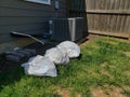 Filthy Trash Bags in Backyard