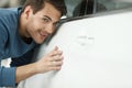 The final check. Handsome young men examining a car at the dealership Royalty Free Stock Photo