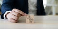 Final decision and business conclusion. A professional hand aligns wooden blocks showing a lightbulb and Conclusion icon. Royalty Free Stock Photo