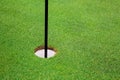 Final hole with flag on golf course with grass