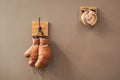 Final sparring. Vintage boxing gloves hang on hook wall background. Boxing gloves and ring bell. Boxing career famous Royalty Free Stock Photo