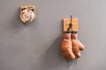 Final sparring. Vintage boxing gloves hang on hook wall background. Boxing gloves and ring bell. Boxing career famous Royalty Free Stock Photo