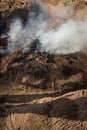 Final stage of uncovering the bonfire with the pieces of clay piled up during the cooking process of the black clay of Gondar in Royalty Free Stock Photo