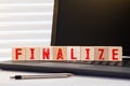 Final word written on wood cube with red background.