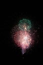 Finale fireworks bursting in a group with a green circle at the top Royalty Free Stock Photo