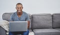 Finally a chance to browse at leisure. Portrait of a handsome young man using a laptop at home. Royalty Free Stock Photo