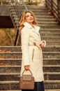 Finally here. girl warm coat stairs background. faux fur coat fashion. stylish business lady leather bag. glamour girl Royalty Free Stock Photo
