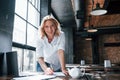 Finally it`s friday. Businesswoman with curly blonde hair indoors in cafe at daytime