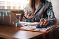 Finance accounting concept. Businesswoman working with smartphone and using a calculator to calculate the numbers of static in Royalty Free Stock Photo