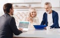 Finance advisor working with aged couple in the house Royalty Free Stock Photo