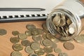 Finance and budget concept. Accounting books, pen and glass jar with coins on office table Royalty Free Stock Photo