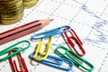 Finance business calculation with chart,color clips,pencil and coins Royalty Free Stock Photo