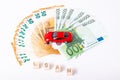 Finance and car loan, saving money for a car or material design concepts. Red car on euro banknotes. Money for car loan payment on