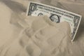 Finance concept. One dollar bank note in the sand Royalty Free Stock Photo